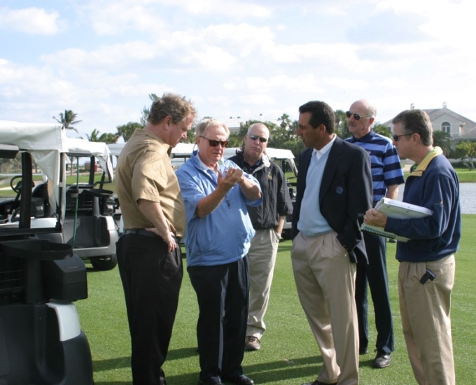 men standing talking on the Jack Nicklaus Golf Course Reopening