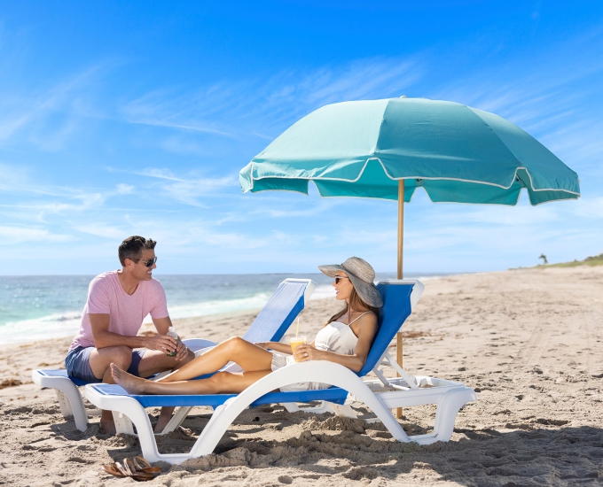 couple lounging on the sailfish beach chairs