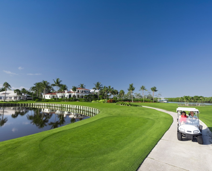 golf cart driving through the jack nicklaus golf course