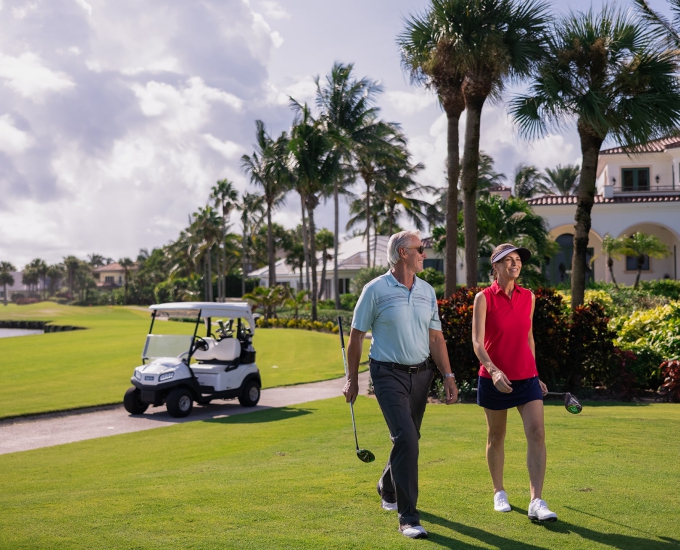 couple walking on the golf course at sailfish point