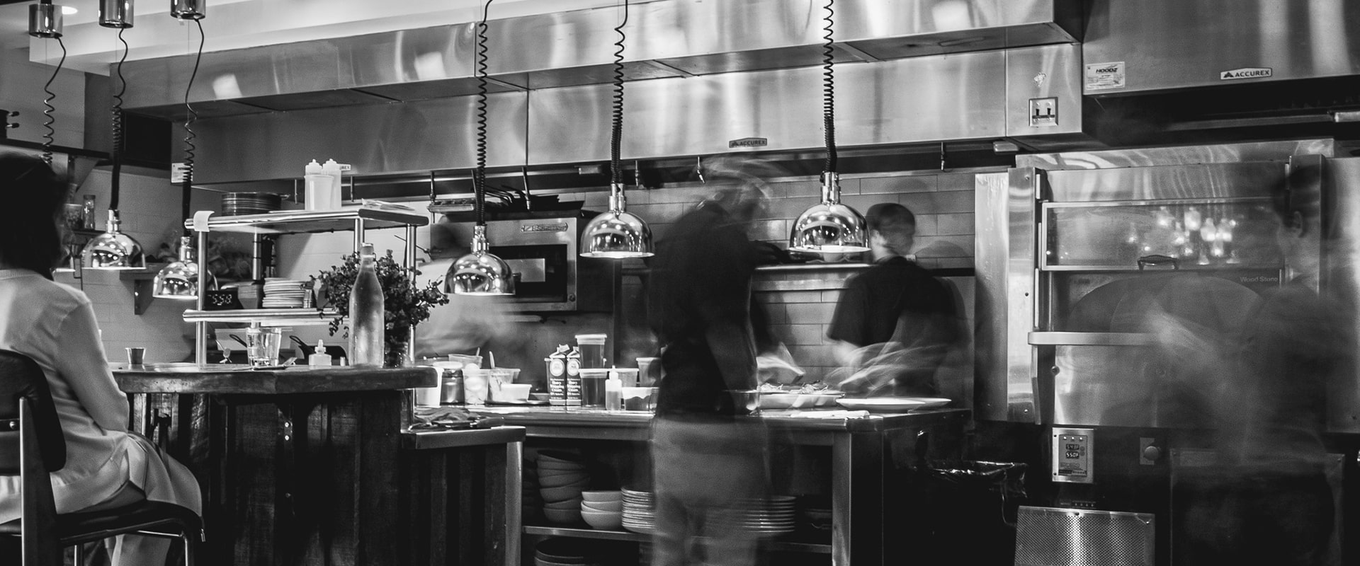 chefs working inside of a kitchen