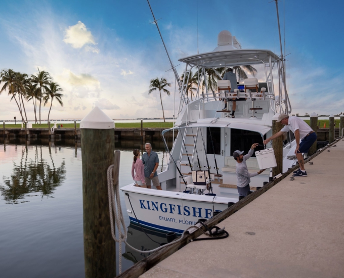 people loading up a boat at the sailfish point yacht club