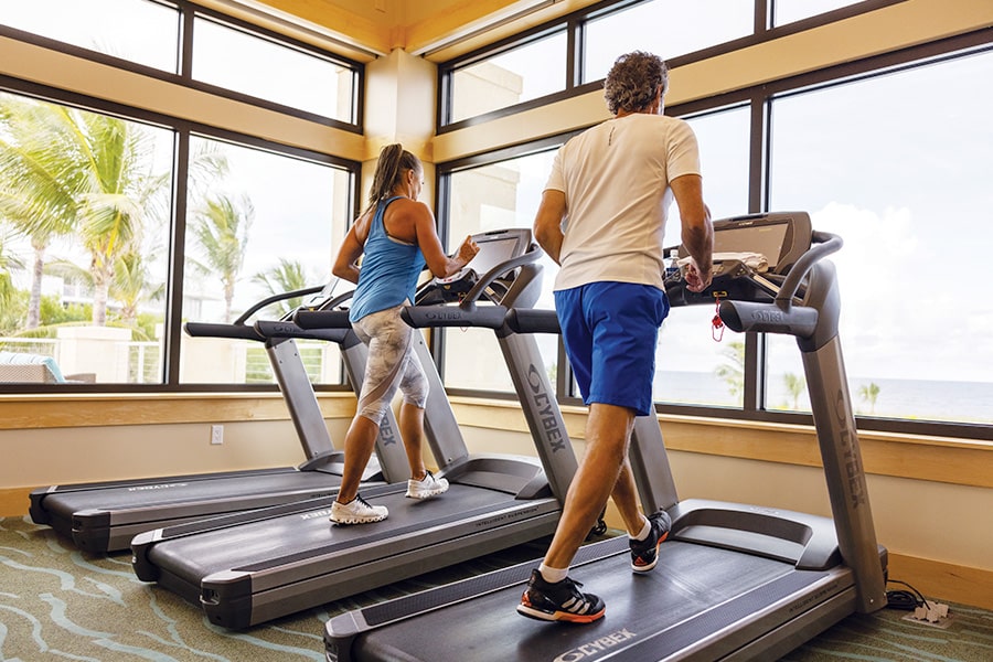two residents on treadmills in sailfish point gym
