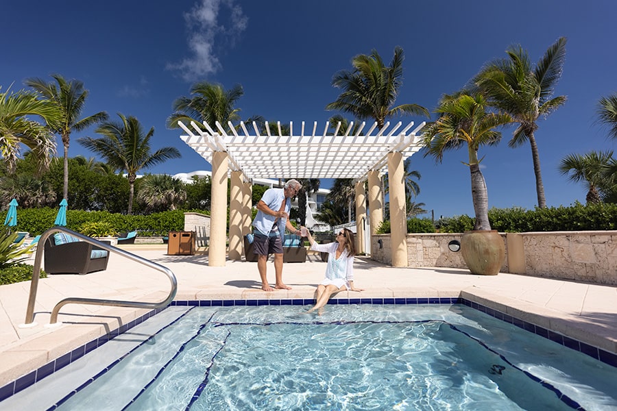 couple at sailfish point oceanfront clubhouse pool