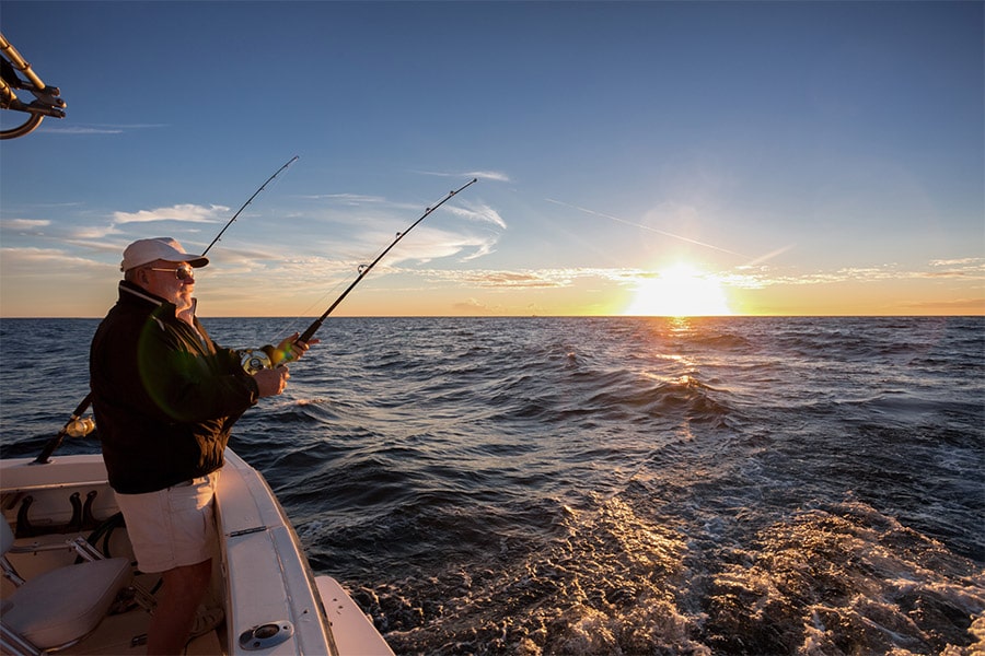 fisherman fishing on open water - natural wonders