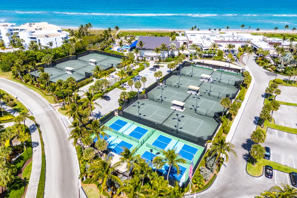 Aerial view of tennis and pickleball courts near the ocean at Sailfish Point