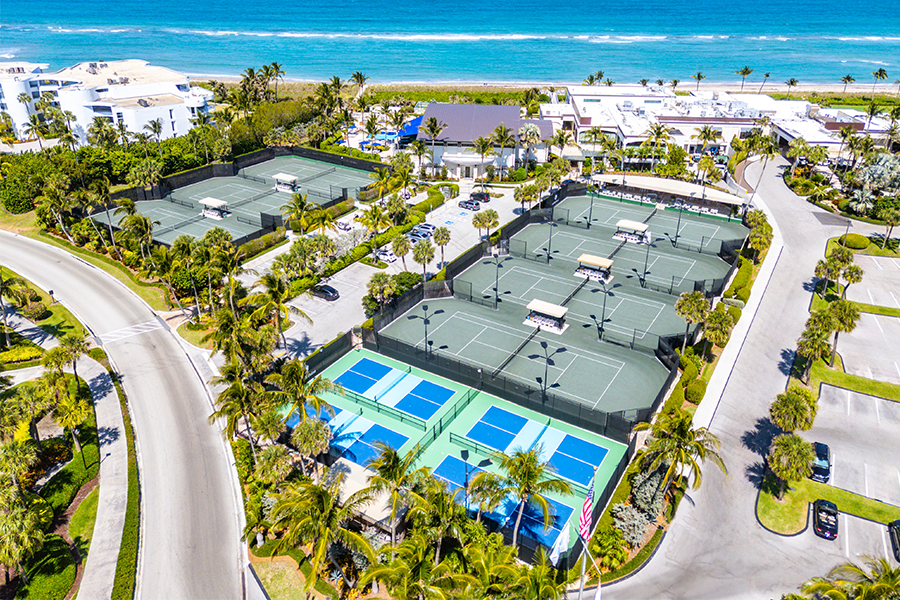 Aerial view of tennis and pickleball courts near the ocean